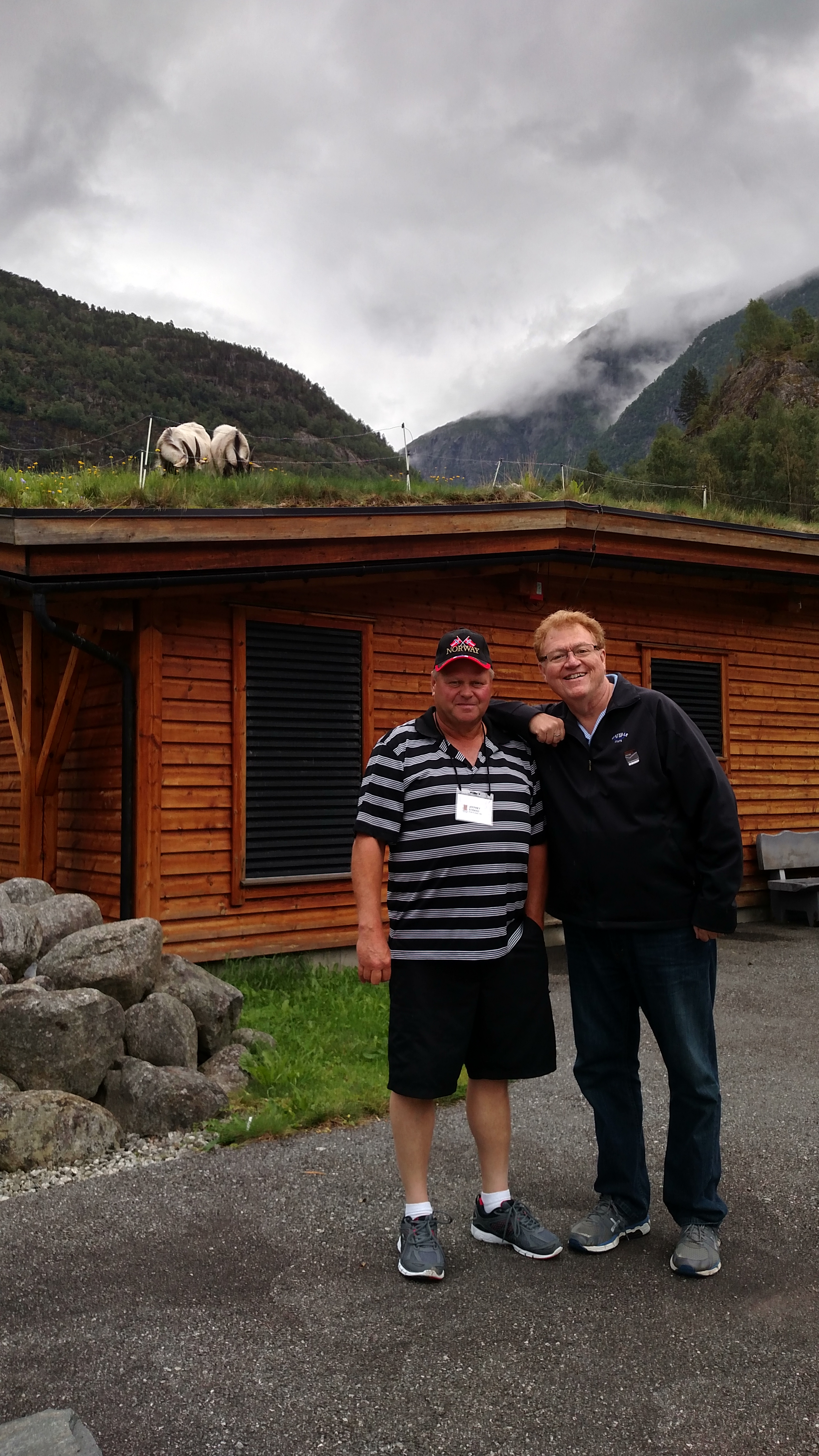 Jeff Strand and John Klocke with goat on a roof.